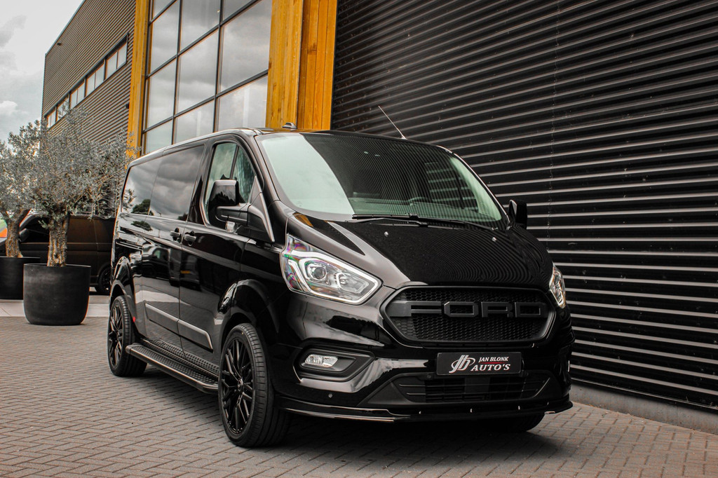 Ford Transit Custom 300 2.0 TDCI L2H1 JB-EDITION / 130PK AUTOMAAT / FULL BLACK / RAPTOR GRILL / SIDE-BARS / TREKHAAK /APPLECARPLAY 8
