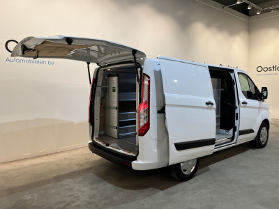 Ford Transit Custom 2.0 TDCI L1H1 Trend 130 PK / Servicebus / Bott Inrichting / Euro 6 / Schuifdeur L+R / Airco / CarPlay / Cruise Control / Camera / Navigatie / Klep / 3-Zits foto 2